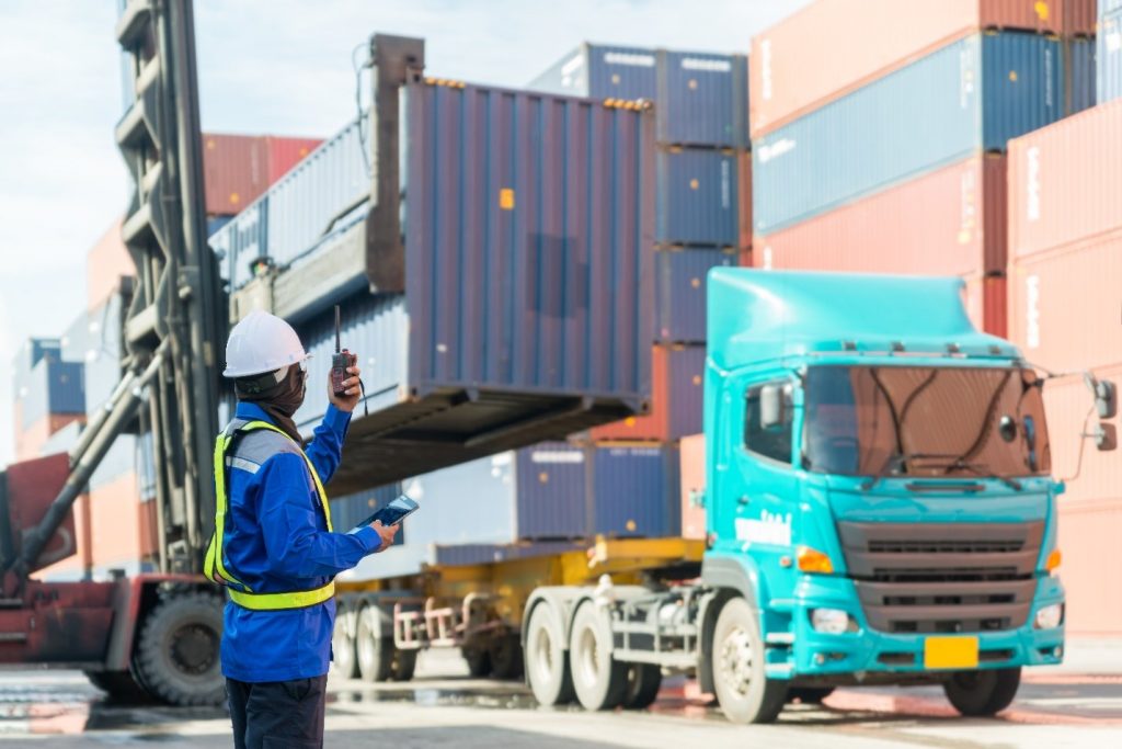 foreman control loading containers box from cargo ship