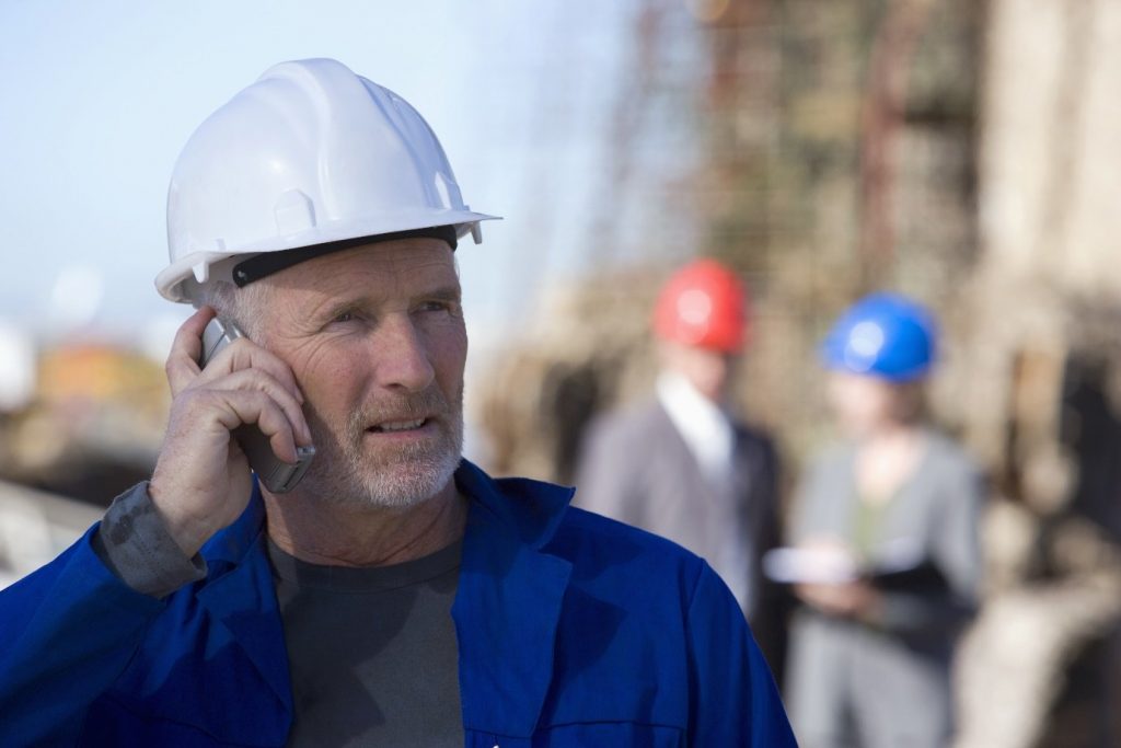 oil rig engineers with on cellphone