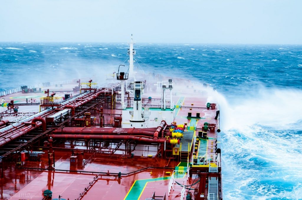 ship with large wave over the bow