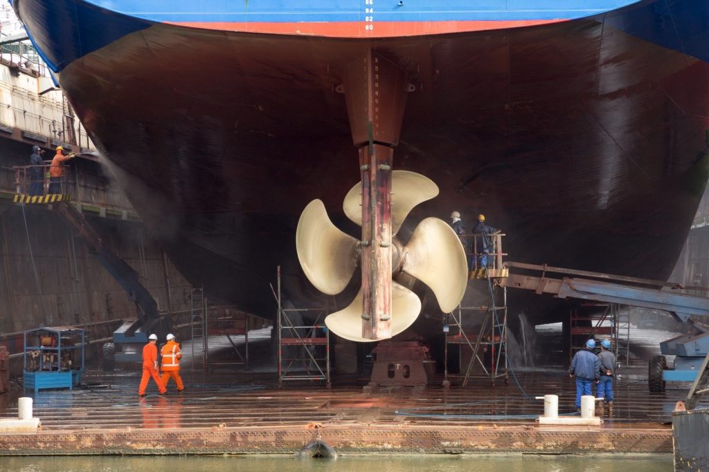 workers repair and cleaning ship dock