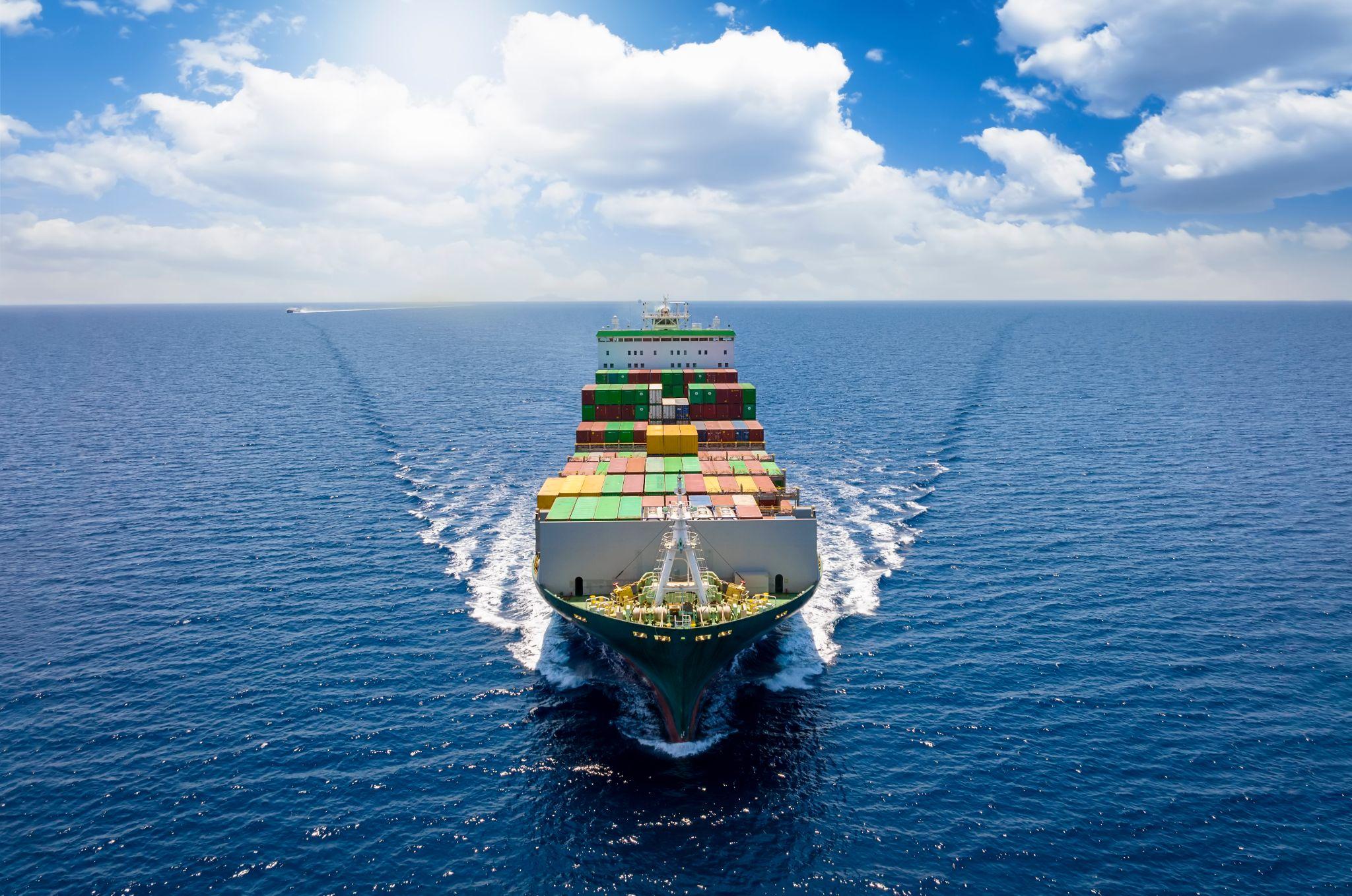 Aerial front view of a loaded container cargo vessel