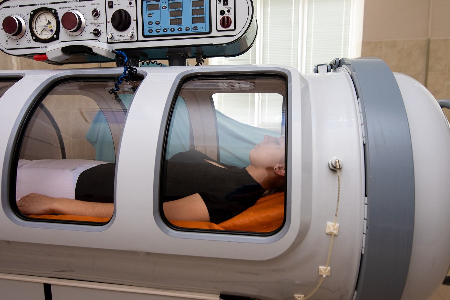 beautiful girl lies in a hyperbaric chamber
