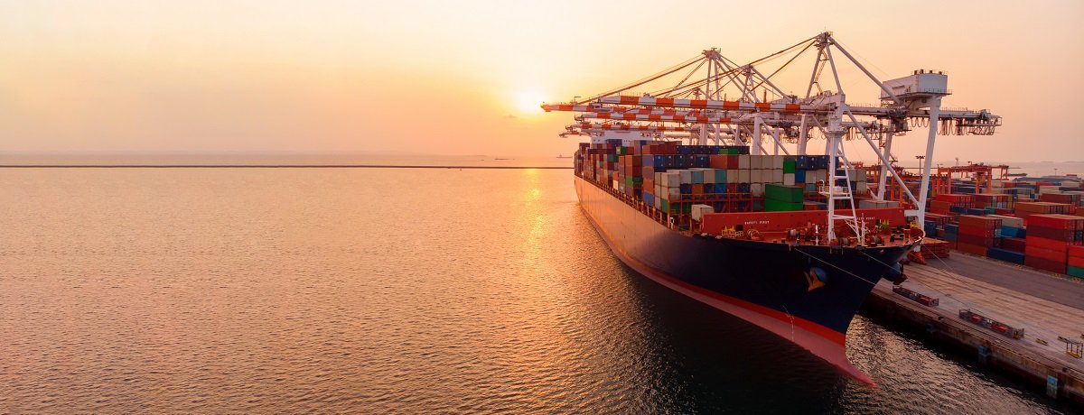 crane loading cargo container to container ship in the terminal yard