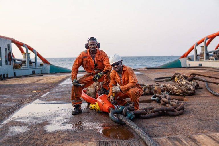 Seamens on deck of offshore vessel wearing PPE personal protective equipment