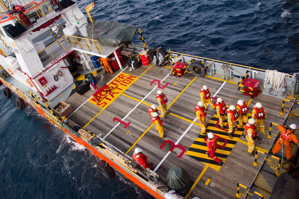 Rig workers are transported on a vessel to offshore rigs