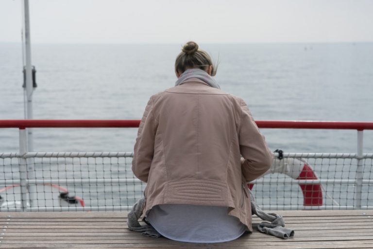 Young man sitting on a boat deck