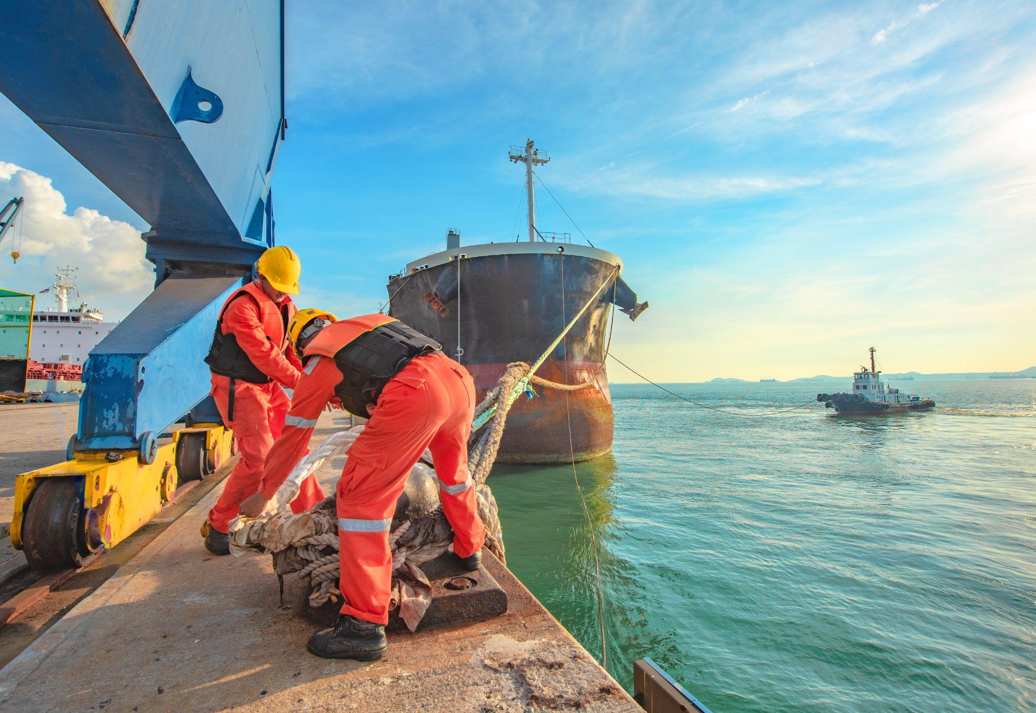 Maritime workers docking a ship at sea