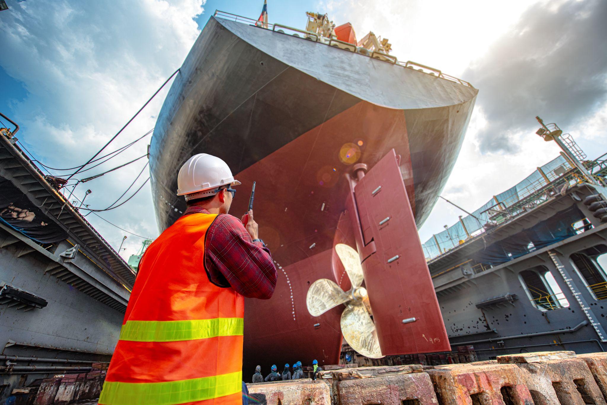 Harbor worker helping repair a ship