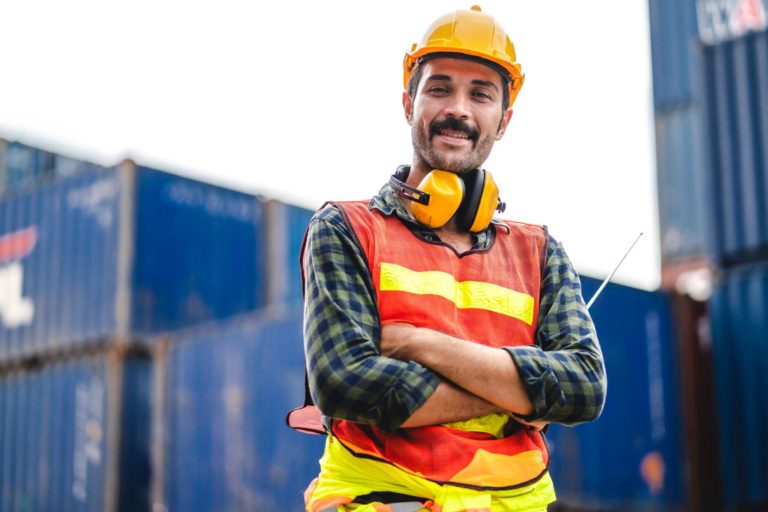 container cargo foreman in helmets working standing and using walkie talkie