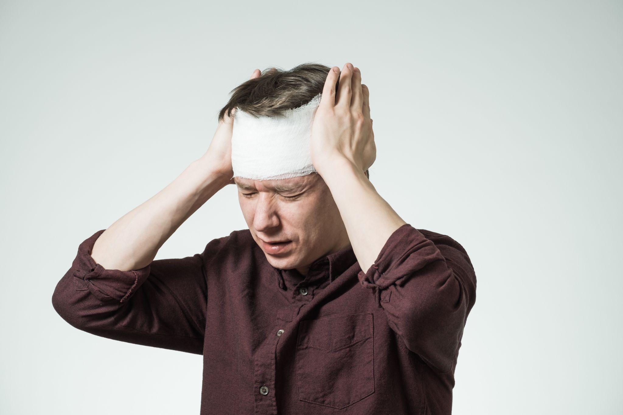 Man with bandage on his head