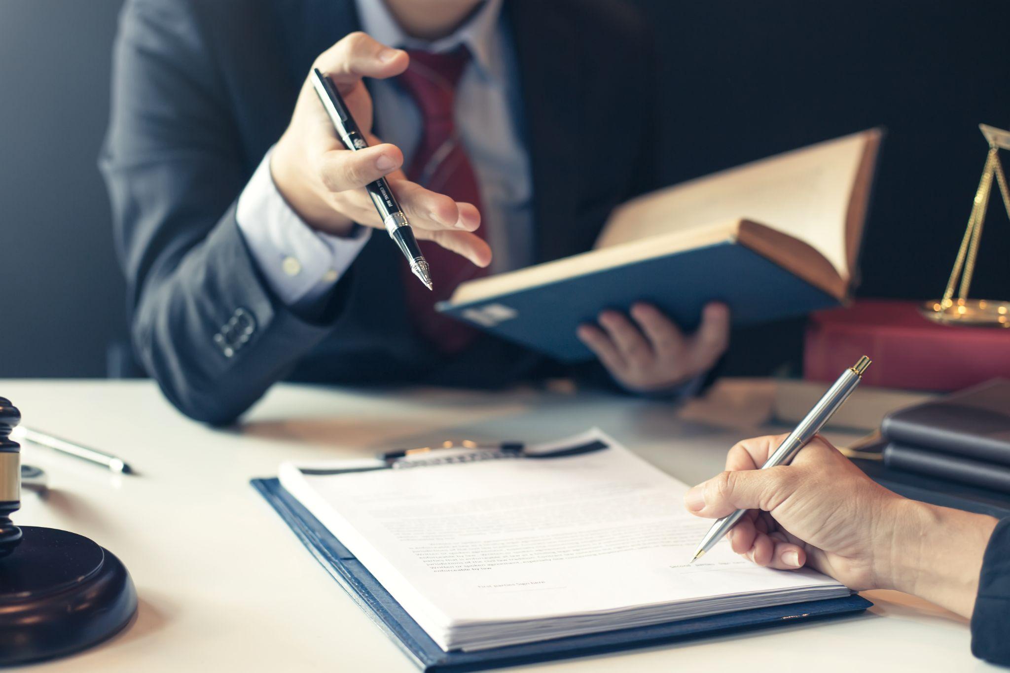 Businessman and lawyer discuss the contract document.