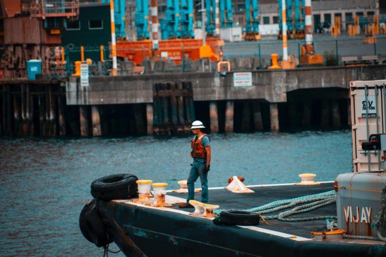 male worker standing on sailboat