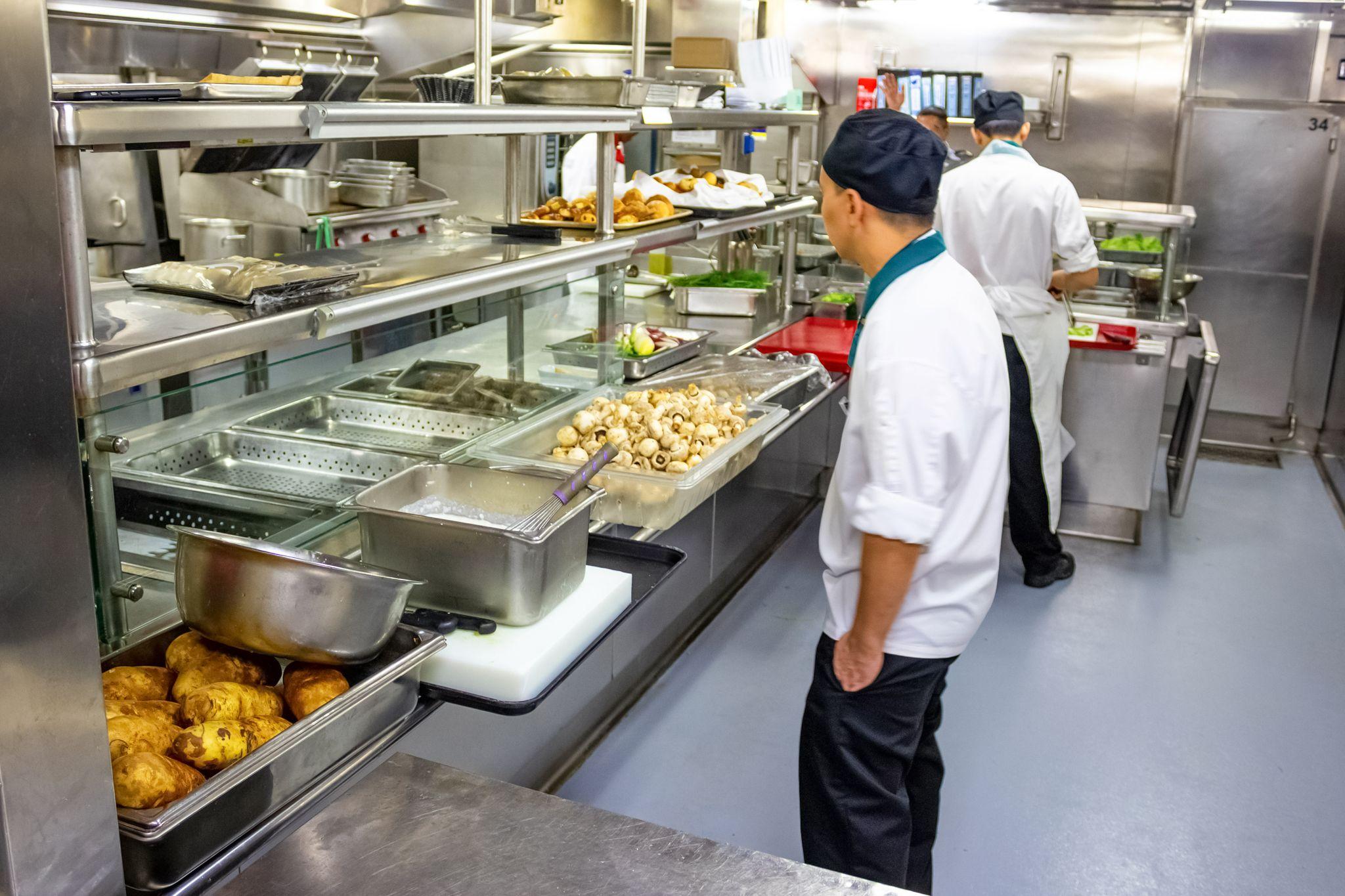 Kitchen crew work in the galley of a cruise ship