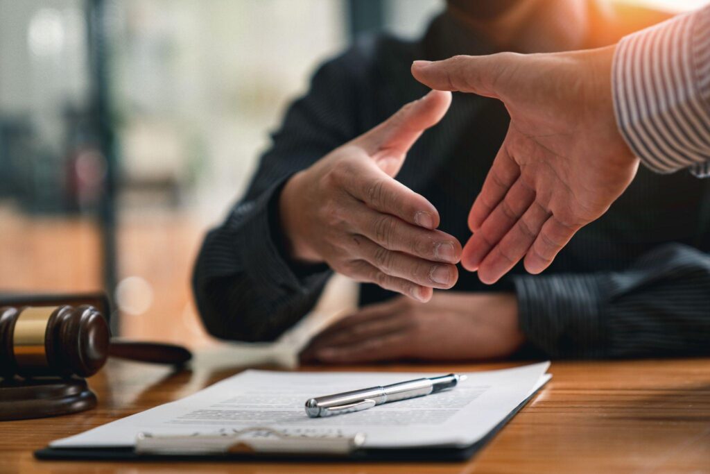 Lawyers shake hands with business people