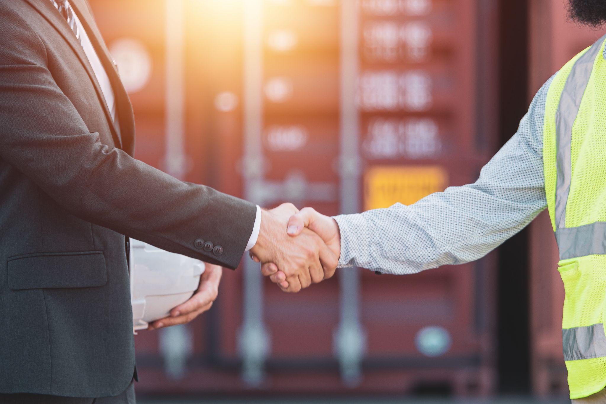 Two men shaking hands on a maritime boat