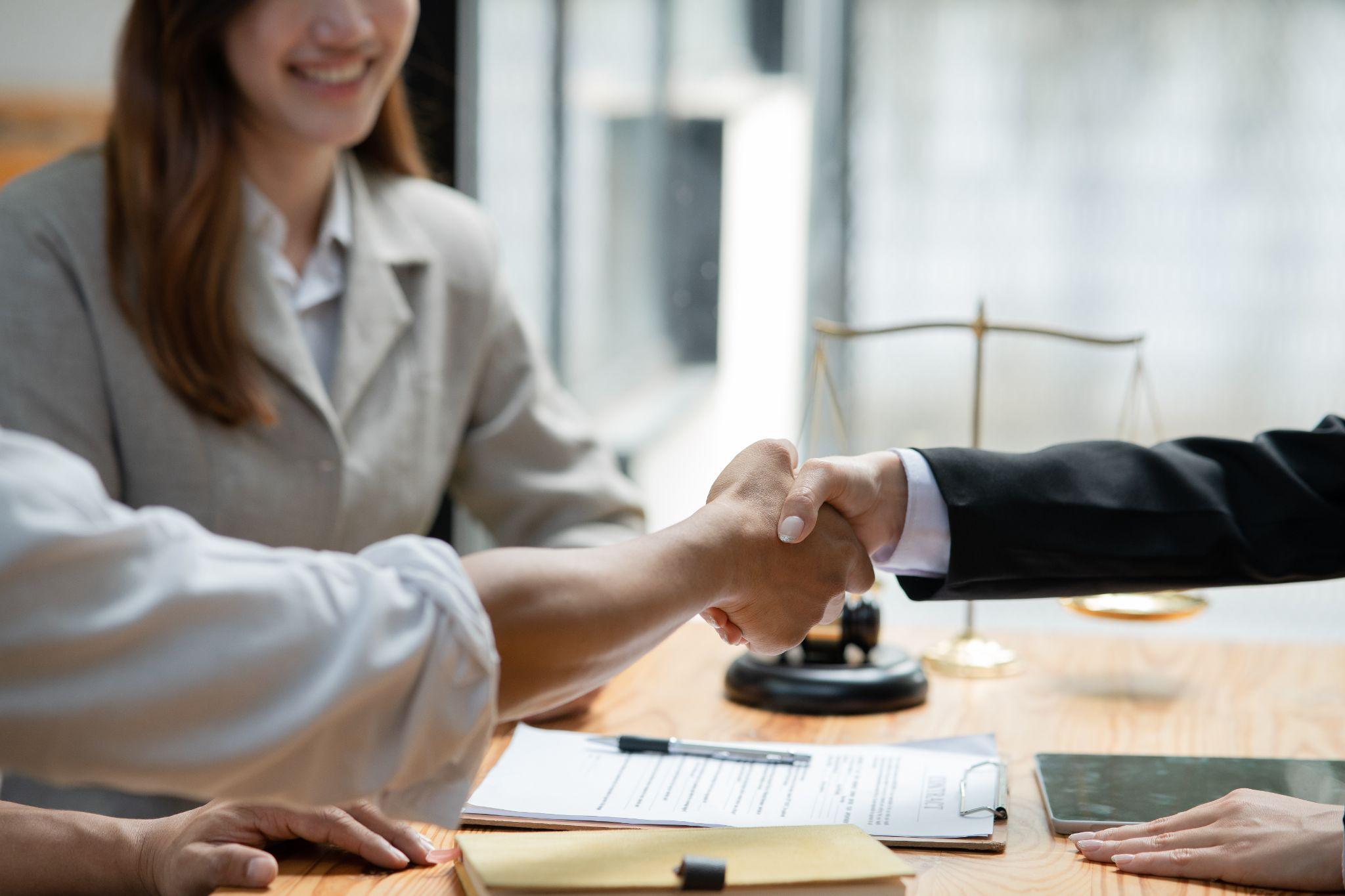 Maritime worker shaking hands with a lawyer